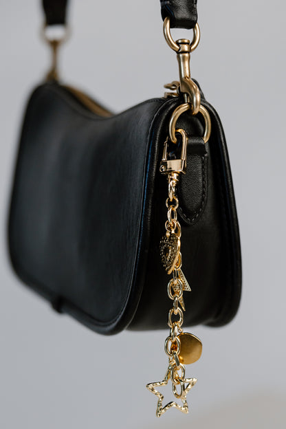 close up bag chain with charms on black purse